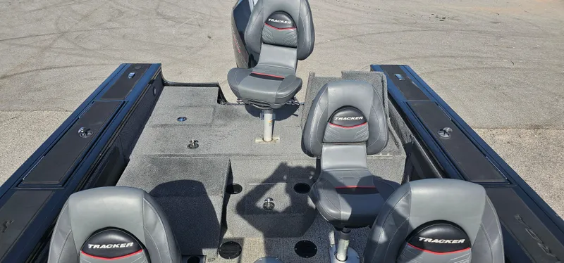Slide: The Image of 2022 Tracker Tagra V19 boat interior with four gray seats on a textured deck. - 19