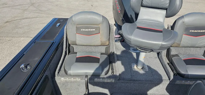 Slide: The Image of Interior of 2022 Tracker Tagra V19 boat with gray and red seating. - 20