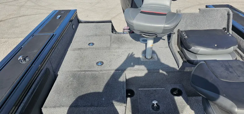 Slide: The Image of Interior of a 2022 Tracker Tagra V19 boat with seating and storage compartments. - 21