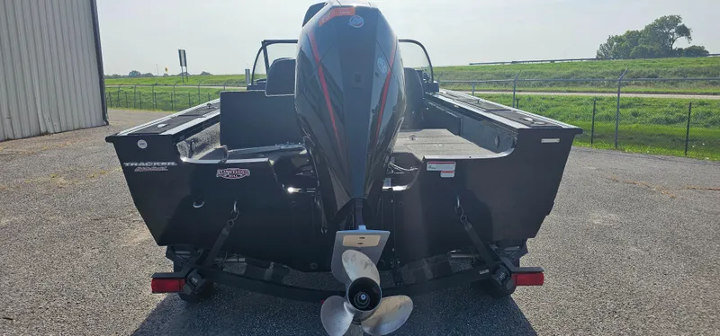 Slide: The Image of 2022 Tracker Tagra V19 boat with outboard motor, parked outdoors. - 3
