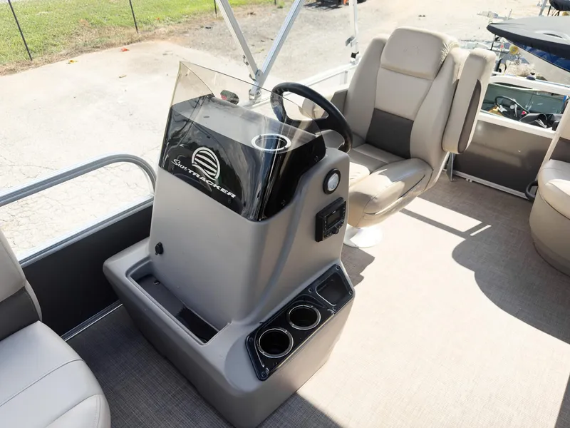 Slide: The Image of 2025 Sun Tracker Party Barge 16 DLX interior with steering console and seating. - 10