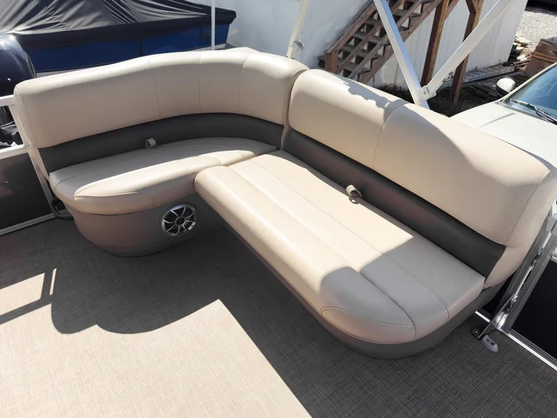 Slide: The Image of 2025 Sun Tracker Party Barge 16 DLX pontoon boat seating, beige upholstery, outdoor setting. - 11