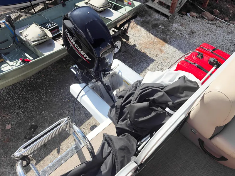 Slide: The Image of 2025 Sun Tracker Party Barge 16 DLX with Mercury outboard motor and boat accessories. - 16