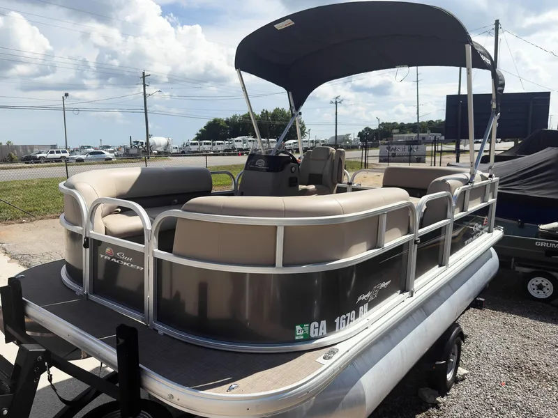 Slide: The Image of 2025 Sun Tracker Party Barge 16 DLX pontoon boat with canopy on trailer. - 19