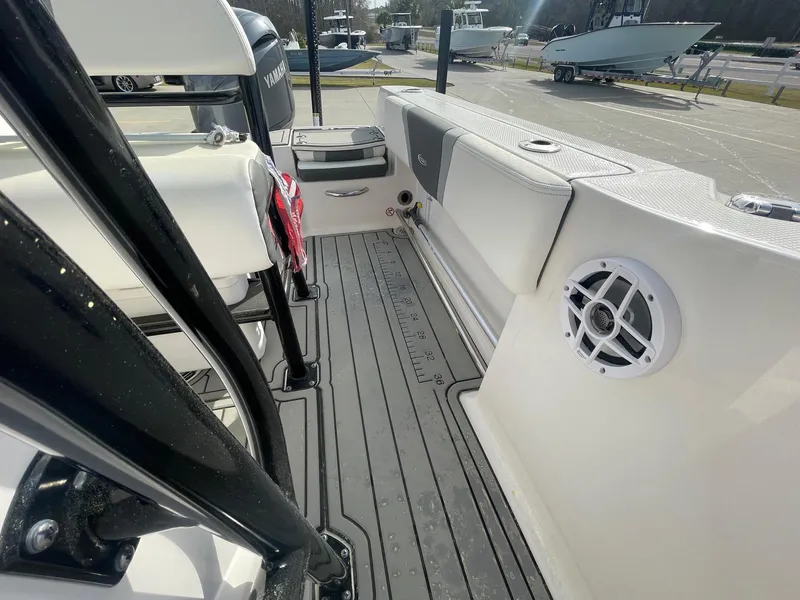 Slide: The Image of 2024 Robalo R200 Center Console boat interior with seating, speaker, and deck details. - 11