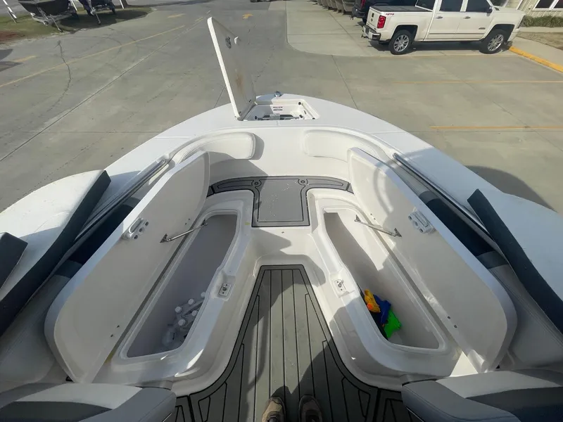 Slide: The Image of 2024 Robalo R200 Center Console boat with open storage compartments on deck. - 14