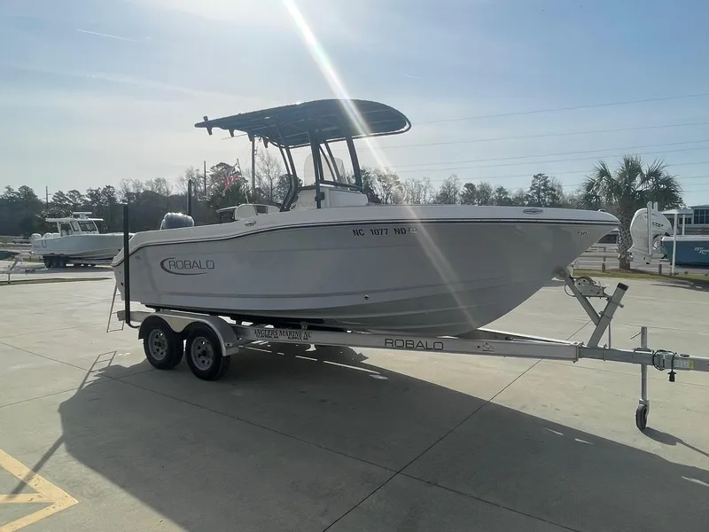 Slide: The Image of 2024 Robalo R200 Center Console boat on trailer in sunny outdoor setting. - 2
