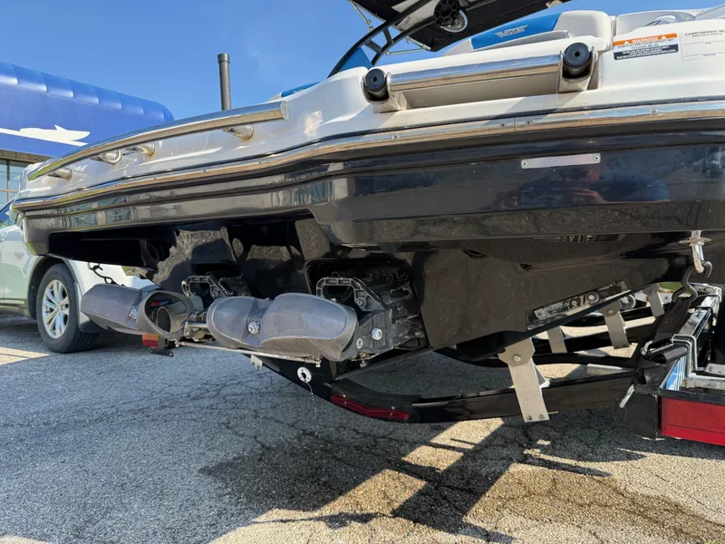 Slide: The Image of 2018 Chaparral Vortex 223 VRX boat rear view, showcasing dual exhausts and trailer. - 5