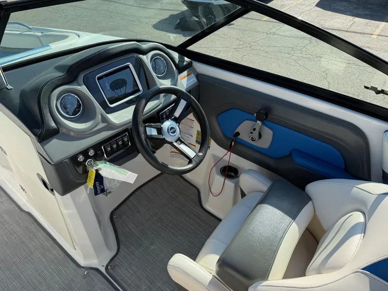Slide: The Image of 2018 Chaparral Vortex 223 VRX boat interior with steering wheel and dashboard controls. - 8