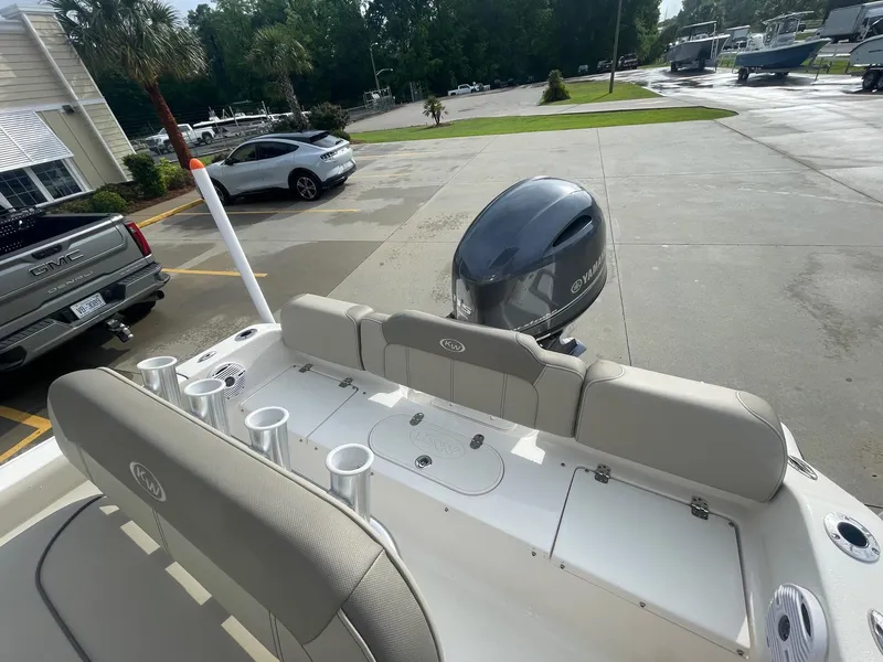 Slide: The Image of 2024 Key West 189 FS boat with Yamaha engine, parked outdoors near vehicles. - 11