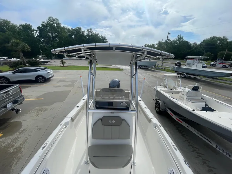 Slide: The Image of 2024 Key West 189 FS boat with T-top, parked in a lot with other vehicles. - 13
