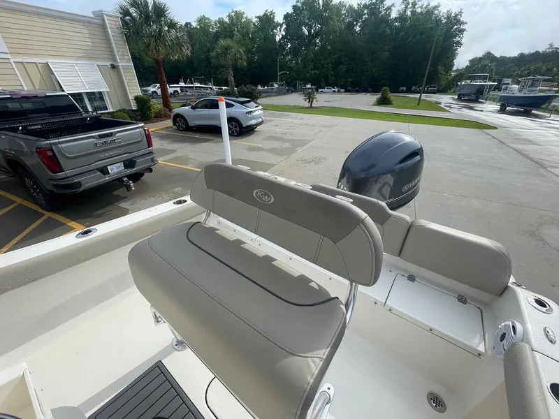 Slide: The Image of 2024 Key West 189 FS boat with Yamaha engine, parked near vehicles and trees. - 15