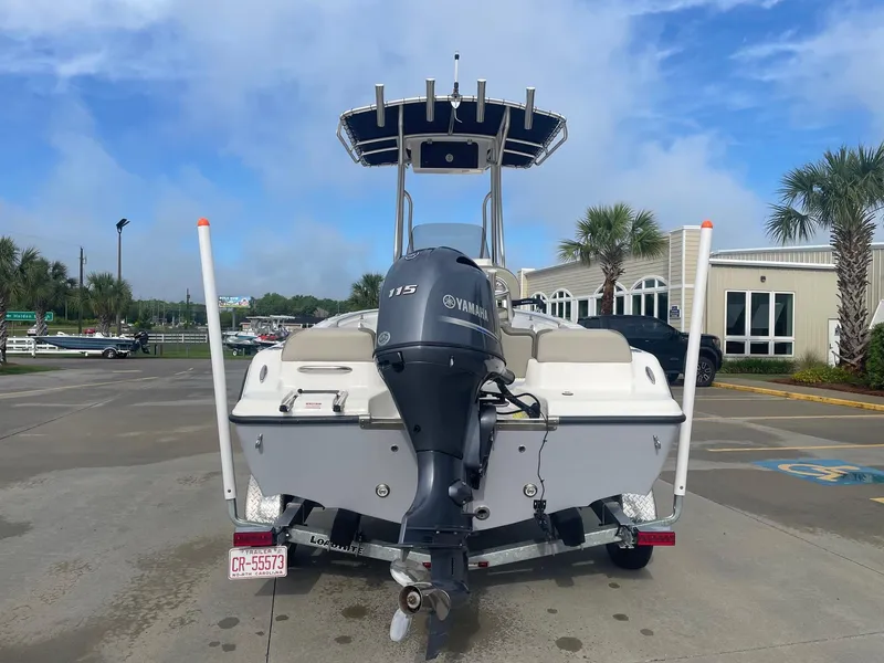 Slide: The Image of 2024 Key West 189 FS boat with Yamaha 115 engine, parked outdoors. - 2