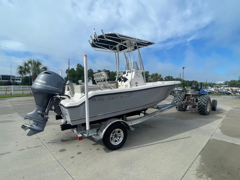 Slide: The Image of 2024 Key West 189 FS boat on trailer, featuring Yamaha outboard motor, parked outdoors. - 3