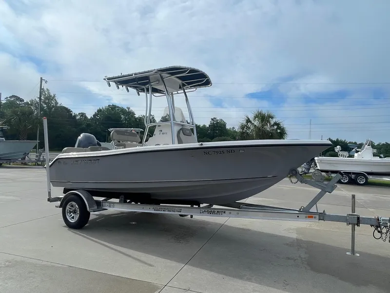 Slide: The Image of 2024 Key West 189 FS boat on trailer, parked outdoors under cloudy sky. - 4