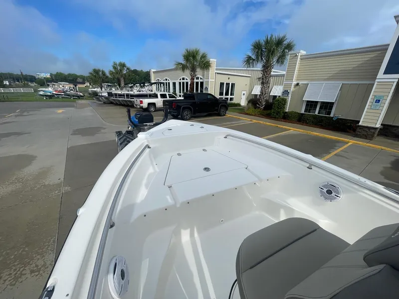 Slide: The Image of 2024 Key West 189 FS boat parked outside dealership with palm trees and clear sky. - 8