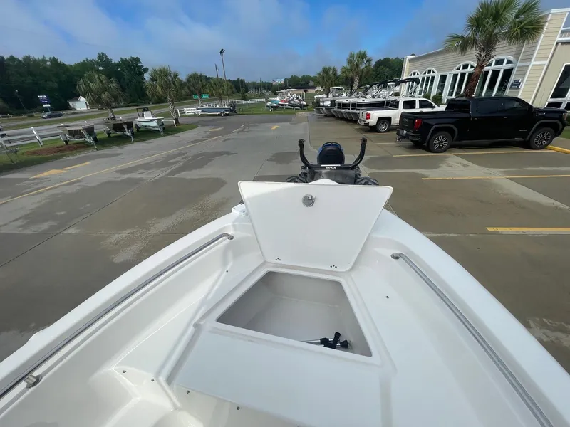 Slide: The Image of 2024 Key West 189 FS boat on display in a parking lot with open storage compartment. - 9