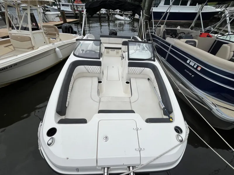 Slide: The Image of 2022 Bayliner DX 2200 boat docked, featuring spacious seating and modern design. - 15