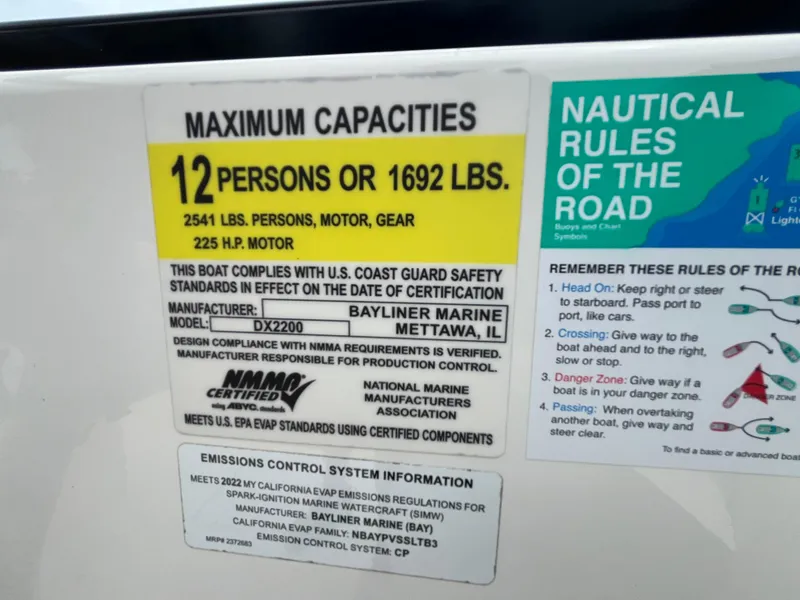 Slide: The Image of Bayliner DX 2200 boat capacity label, 12 persons or 1692 lbs, 225 HP motor, 2022 model. - 18