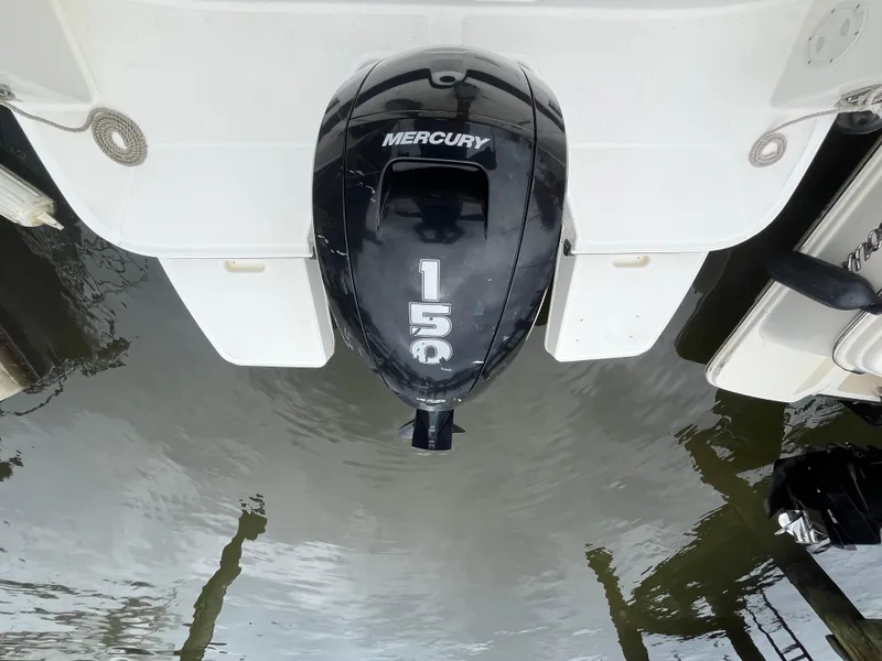Slide: The Image of Bayliner DX 2200 (2022) with Mercury 150 outboard motor on water. - 20