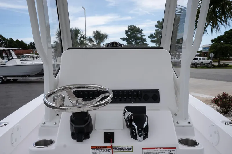Slide: The Image of 2026 Twin Vee 22 Bay Cat boat console with steering wheel and controls. - 11