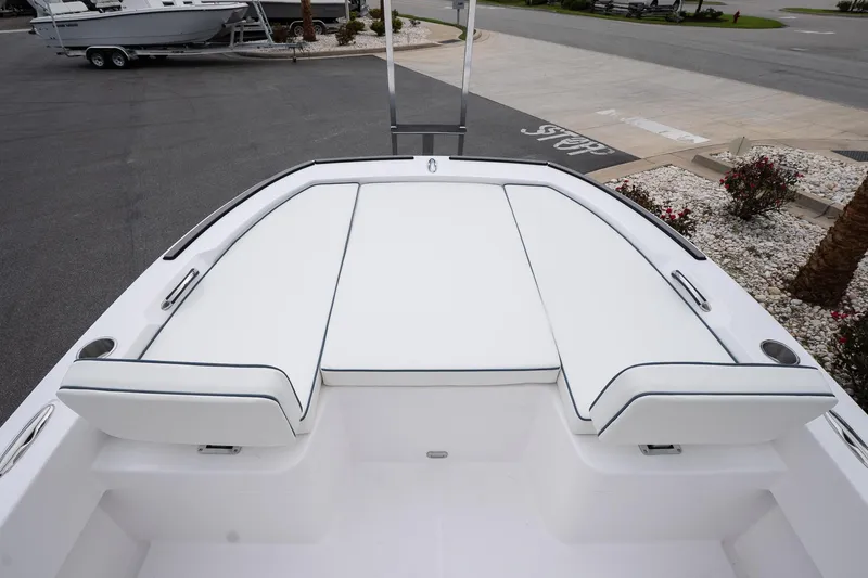 Slide: The Image of 2026 Twin Vee 22 Bay Cat boat with white cushioned seating and sleek design. - 13