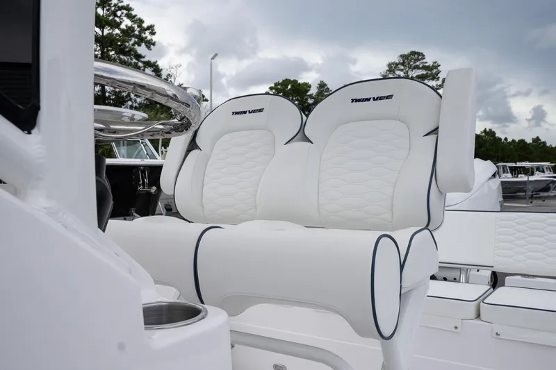 Slide: The Image of 2026 Twin Vee 22 Bay Cat boat with luxurious white seating and sleek design. - 14