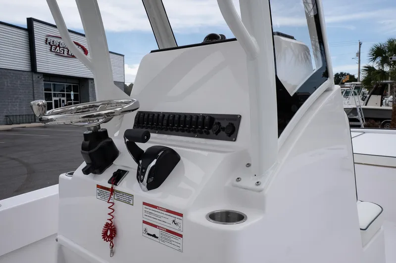 Slide: The Image of 2026 Twin Vee 22 Bay Cat boat console with steering wheel and controls. - 17