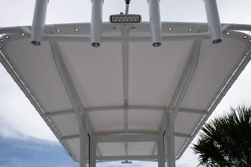 Slide: The Image of T-top view of 2026 Twin Vee 22 Bay Cat boat against sky. - 18