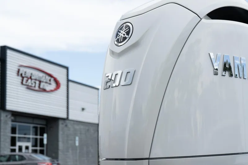 Slide: The Image of 2026 Twin Vee 22 Bay Cat with Yamaha 200 engine near Performance East building. - 7