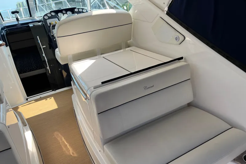 Slide: The Image of 2015 Tiara Yachts 3100 Coronet interior with white seating and helm controls. - 10