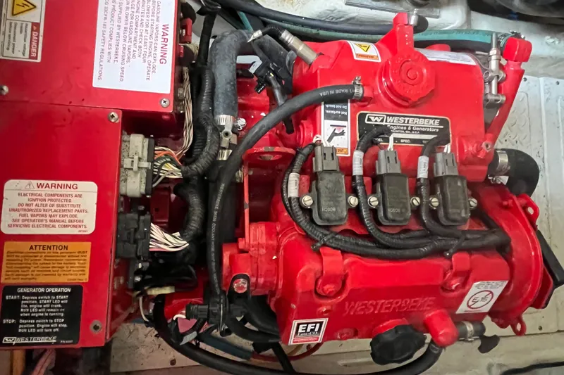 Slide: The Image of Engine compartment of a 2015 Tiara Yachts 3100 Coronet, featuring a red Westerbeke generator. - 15
