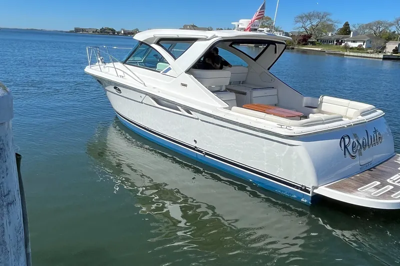 Slide: The Image of 2015 Tiara Yachts 3100 Coronet boat on calm water, rear view. - 2