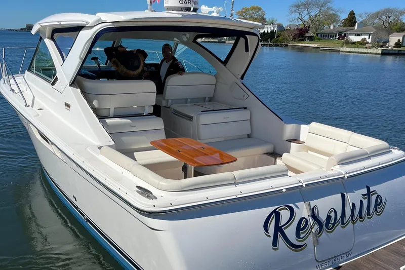 Slide: The Image of 2015 Tiara Yachts 3100 Coronet boat named "Resolute" on calm water. - 4
