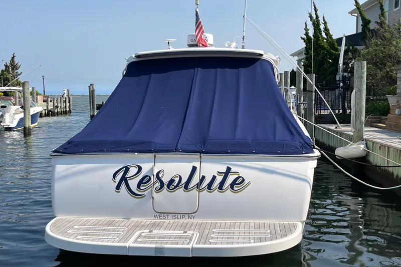 Slide: The Image of 2015 Tiara Yachts 3100 Coronet named "Resolute" docked with blue cover. - 5