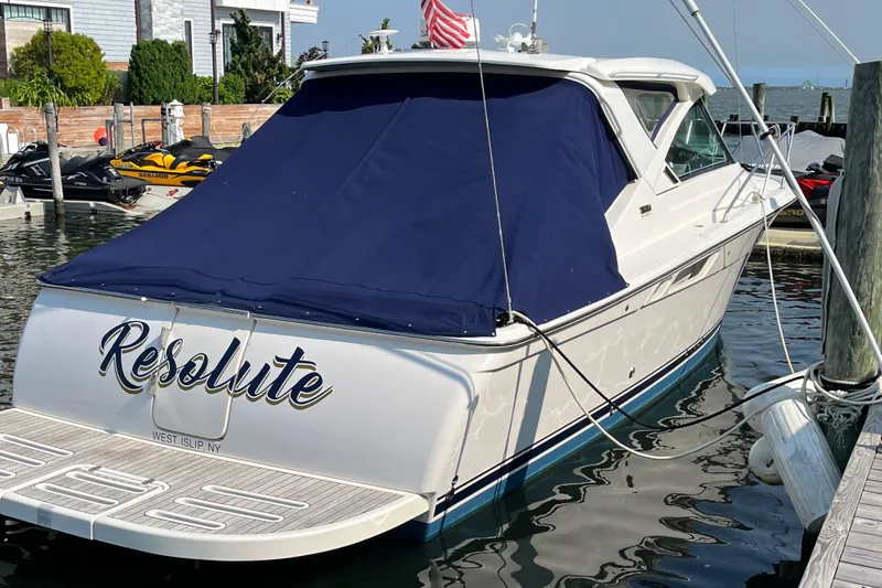 Slide: The Image of 2015 Tiara Yachts 3100 Coronet docked, featuring a blue cover and "Resolute" on the stern. - 6