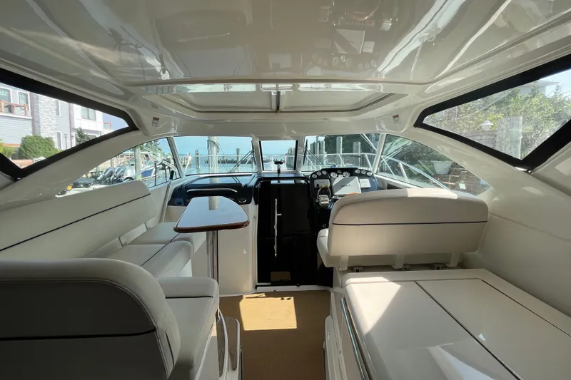 Slide: The Image of 2015 Tiara Yachts 3100 Coronet interior with seating and helm, showcasing luxury design. - 7