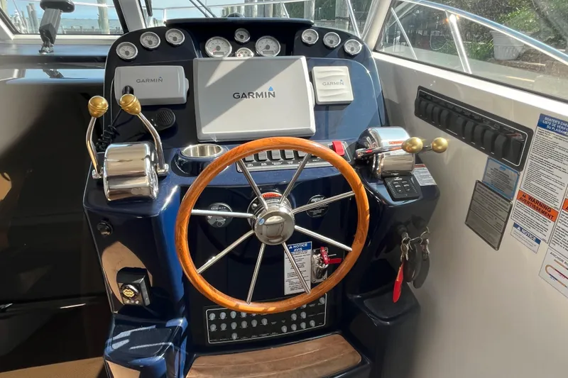 Slide: The Image of Helm of 2015 Tiara Yachts 3100 Coronet with Garmin navigation system and wooden steering wheel. - 8