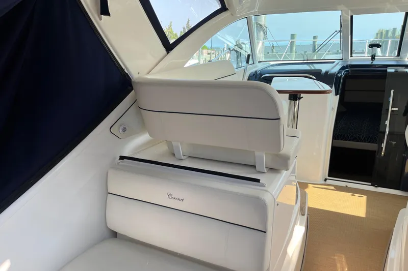 Slide: The Image of 2015 Tiara Yachts 3100 Coronet interior with white seating and helm view. - 9
