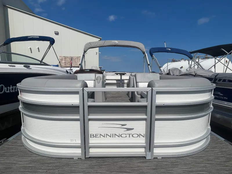 Slide: The Image of 2021 Bennington 23L pontoon boat docked under clear blue sky. - 10