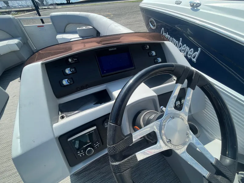 Slide: The Image of 2021 Bennington 23L boat dashboard with steering wheel and control panel. - 19