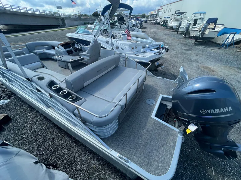 Slide: The Image of 2021 Bennington 23L pontoon boat with Yamaha engine, docked in a marina. - 7