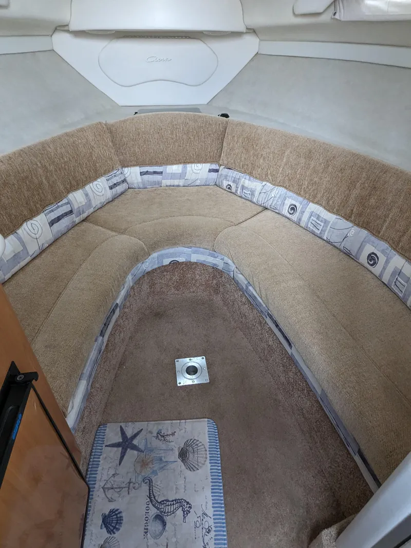 Slide: The Image of Interior of 2002 Bayliner 245 Ciera boat with cozy seating area. - 14
