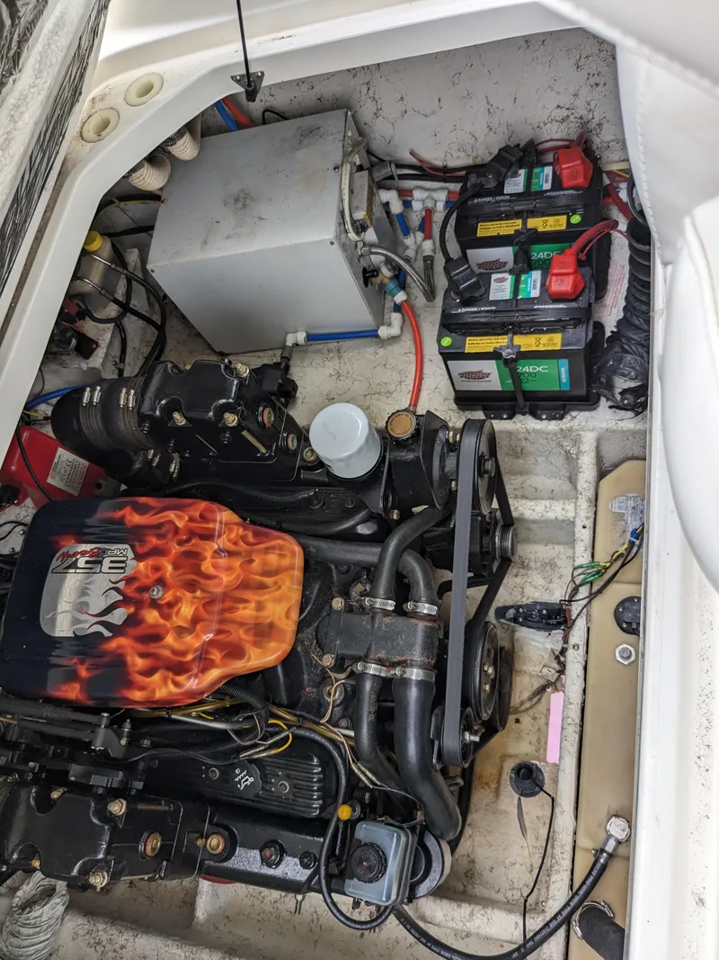 Slide: The Image of Engine compartment of a 2002 Bayliner 245 Ciera with visible batteries and components. - 19