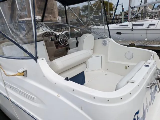 Slide: The Image of 2002 Bayliner 245 Ciera boat interior with helm and seating, docked at marina. - 5