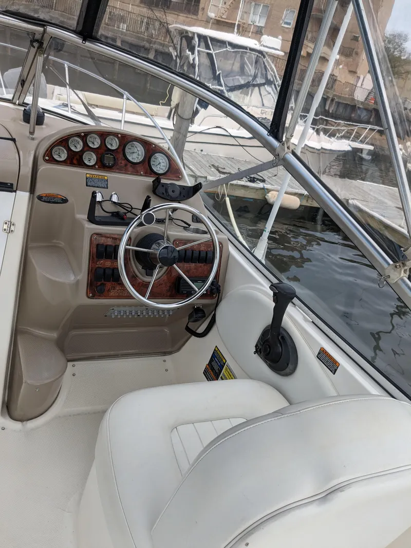 Slide: The Image of 2002 Bayliner 245 Ciera boat cockpit with steering wheel and instrument panel. - 6
