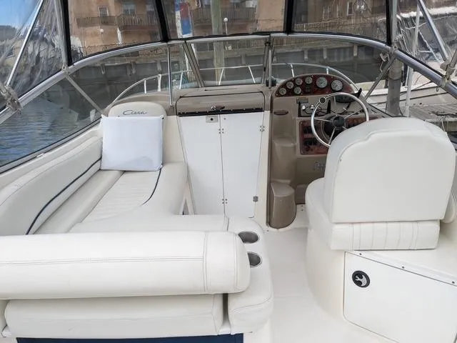 Slide: The Image of 2002 Bayliner 245 Ciera boat interior with white seating and steering console. - 8