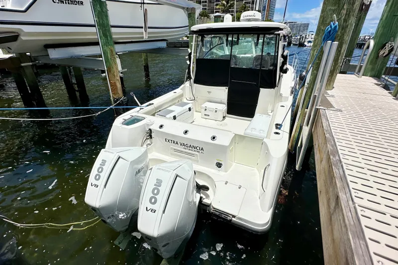 The Image of 2015 Boston Whaler 315 Conquest docked, featuring twin Mercury 300 V8 engines. - 0