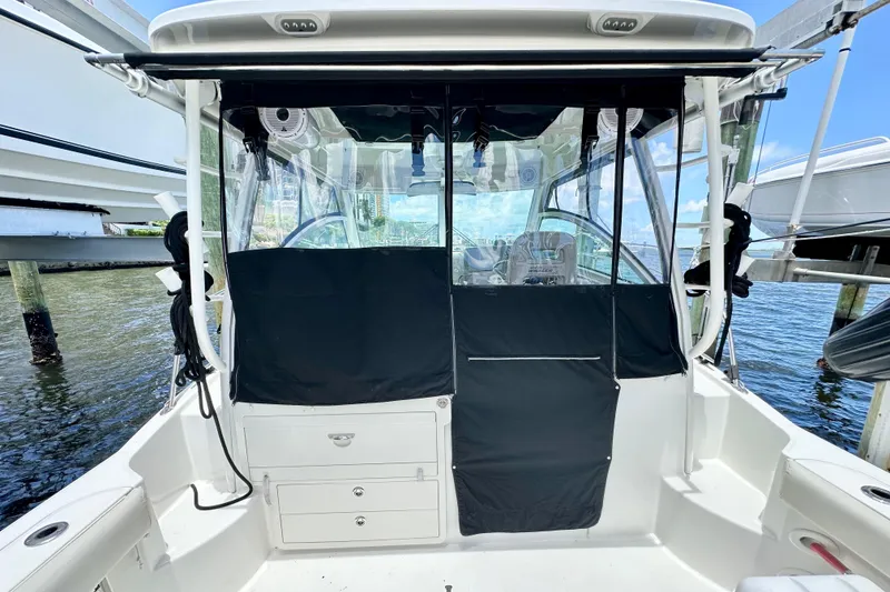 Slide: The Image of 2015 Boston Whaler 315 Conquest boat interior with covered cockpit and clear windows. - 12