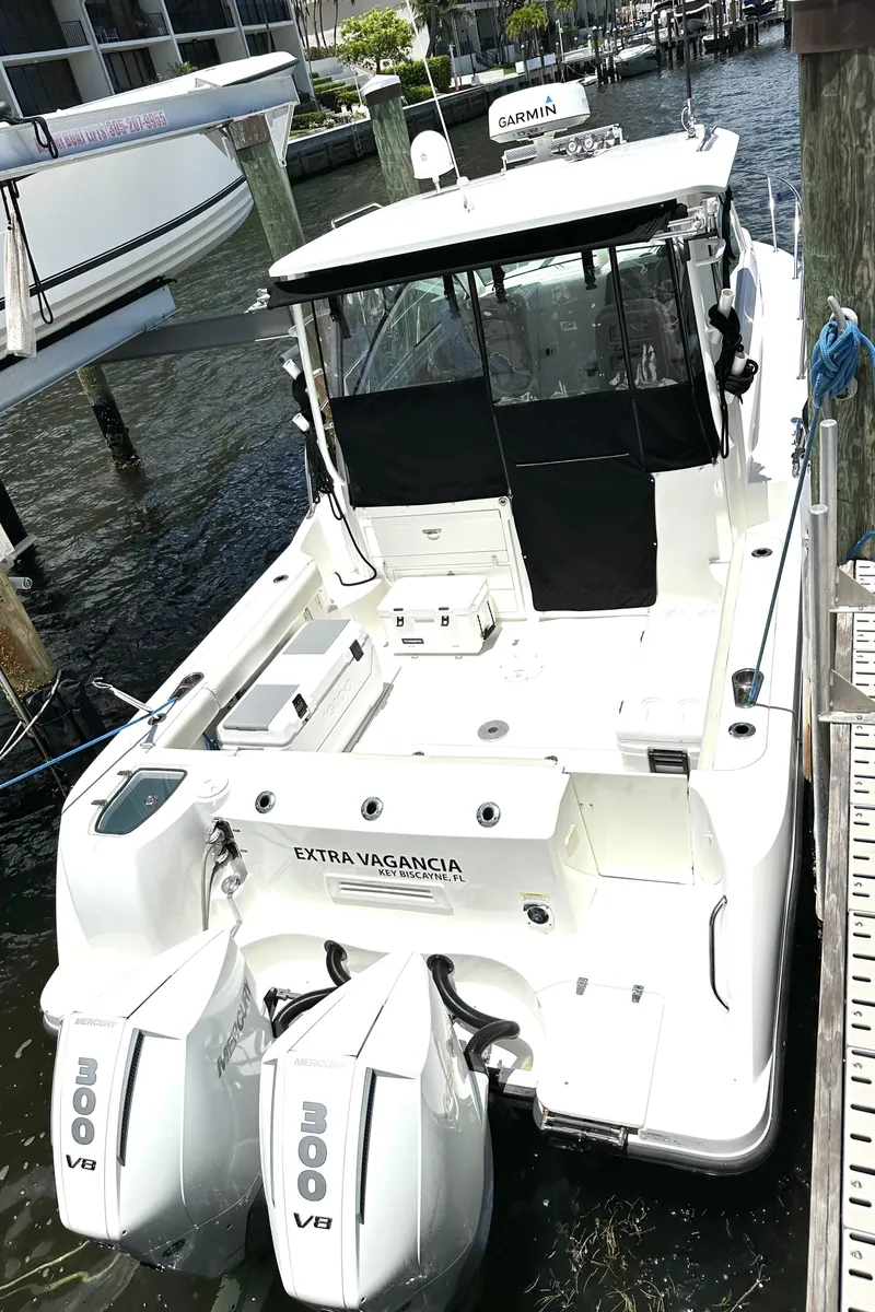 Slide: The Image of 2015 Boston Whaler 315 Conquest boat docked with twin 300 V8 engines. - 13
